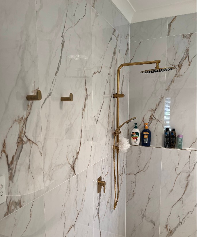 Luxury marble shower with brass fixtures